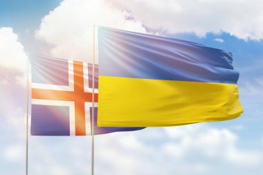 Sunny blue sky and flags of ukraine and iceland