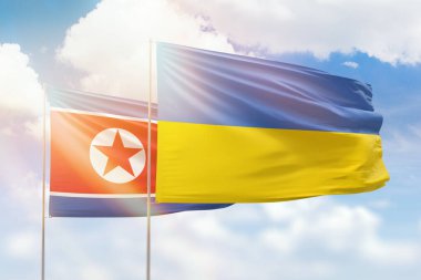 Sunny blue sky and flags of ukraine and north korea