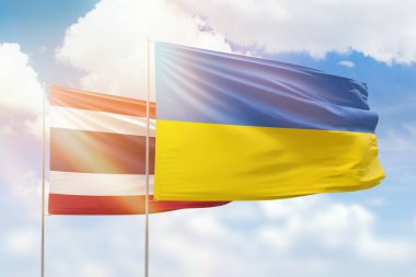 Sunny blue sky and flags of ukraine and thailand