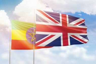 Sunny blue sky and flags of united kingdom and ethiopia