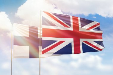 Sunny blue sky and flags of united kingdom and finland