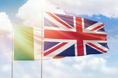 Sunny blue sky and flags of united kingdom and ireland