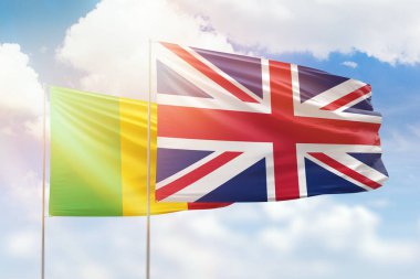 Sunny blue sky and flags of united kingdom and mali