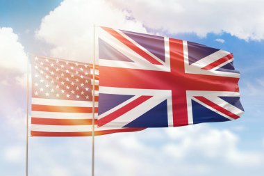 Sunny blue sky and flags of united kingdom and usa