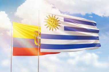 Sunny blue sky and flags of uruguay and ecuador