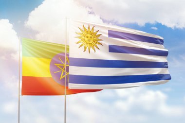 Sunny blue sky and flags of uruguay and ethiopia