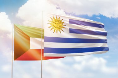 Sunny blue sky and flags of uruguay and kuwait
