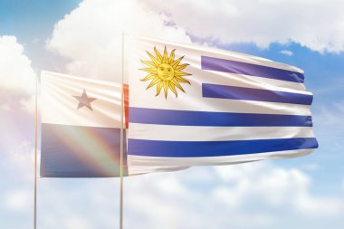 Sunny blue sky and flags of uruguay and panama