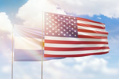 Sunny blue sky and flags of united states of america and argentina