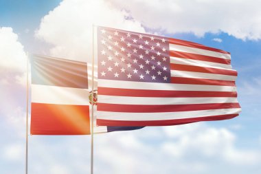 Sunny blue sky and flags of united states of america and dominican republic