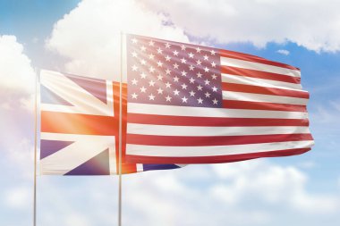 Sunny blue sky and flags of united states of america and great britain