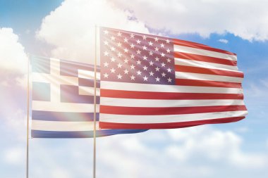 Sunny blue sky and flags of united states of america and greece