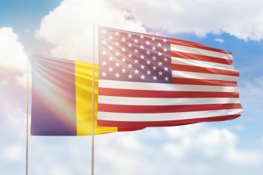 Sunny blue sky and flags of united states of america and romania