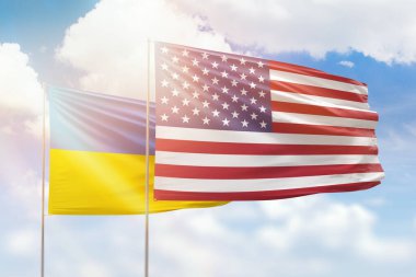 Sunny blue sky and flags of united states of america and ukraine