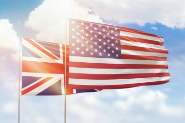 Sunny blue sky and flags of united states of america and united kingdom
