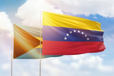 Sunny blue sky and flags of venezuela and bahamas