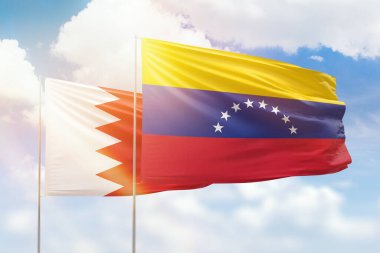 Sunny blue sky and flags of venezuela and bahrain