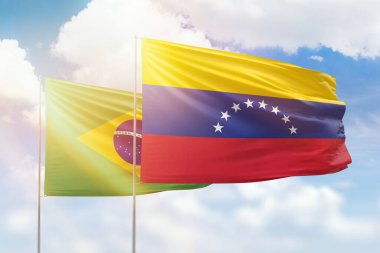 Sunny blue sky and flags of venezuela and brazil