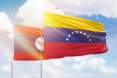 Sunny blue sky and flags of venezuela and laos