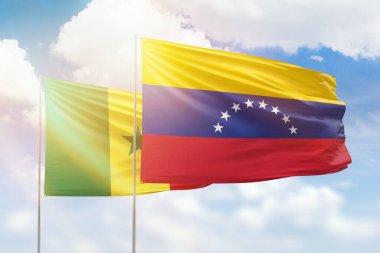 Sunny blue sky and flags of venezuela and senegal