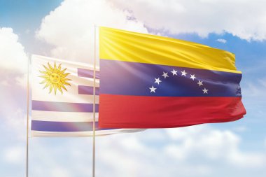 Sunny blue sky and flags of venezuela and uruguay