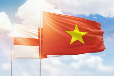 Sunny blue sky and flags of vietnam and england