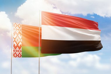Sunny blue sky and flags of yemen and belarus
