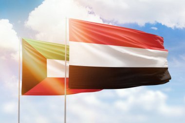 Sunny blue sky and flags of yemen and kuwait