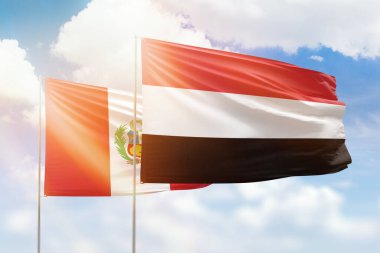 Sunny blue sky and flags of yemen and peru