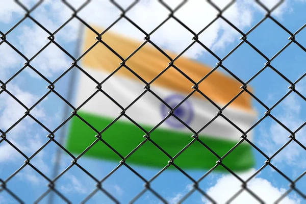 A steel mesh against the background of a blue sky and a flagpole with the flag of india