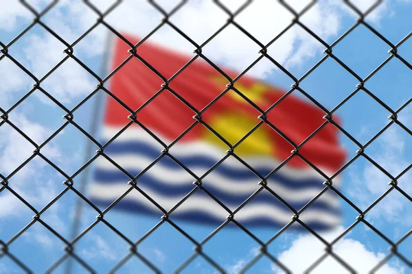 A steel mesh against the background of a blue sky and a flagpole with the flag of kiribati