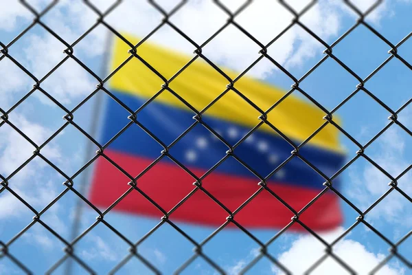 A steel mesh against the background of a blue sky and a flagpole with the flag of venezuela