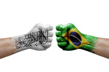 Two hands punch to each others on white background. Country flags painted fists, conflict crisis concept between afghanistan and brazil