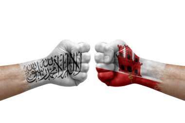 Two hands punch to each others on white background. Country flags painted fists, conflict crisis concept between afghanistan and gibraltar