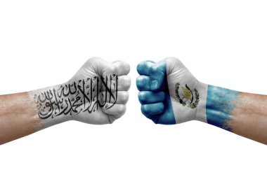 Two hands punch to each others on white background. Country flags painted fists, conflict crisis concept between afghanistan and guatemala