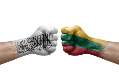 Two hands punch to each others on white background. Country flags painted fists, conflict crisis concept between afghanistan and lithuania