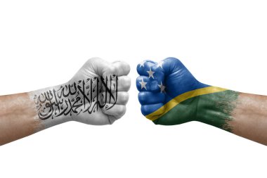 Two hands punch to each others on white background. Country flags painted fists, conflict crisis concept between afghanistan and solomon islands