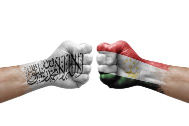 Two hands punch to each others on white background. Country flags painted fists, conflict crisis concept between afghanistan and tajikistan