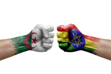 Two hands punch to each others on white background. Country flags painted fists, conflict crisis concept between algeria and ethiopia