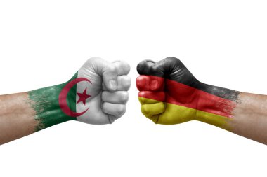 Two hands punch to each others on white background. Country flags painted fists, conflict crisis concept between algeria and germany
