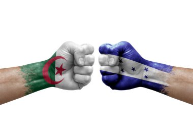 Two hands punch to each others on white background. Country flags painted fists, conflict crisis concept between algeria and honduras