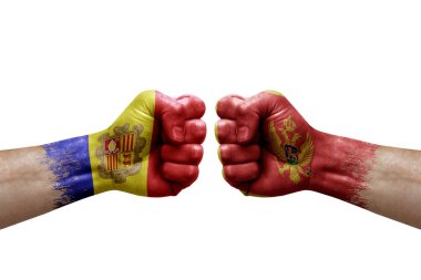 Two hands punch to each others on white background. Country flags painted fists, conflict crisis concept between andorra and montenegro