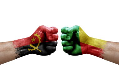 Two hands punch to each others on white background. Country flags painted fists, conflict crisis concept between angola and benin