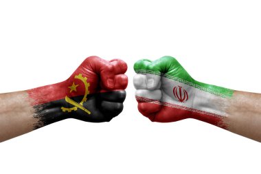 Two hands punch to each others on white background. Country flags painted fists, conflict crisis concept between angola and iran