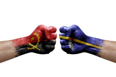 Two hands punch to each others on white background. Country flags painted fists, conflict crisis concept between angola and nauru