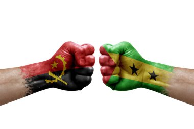 Two hands punch to each others on white background. Country flags painted fists, conflict crisis concept between angola and sao tome and principe