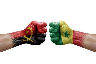 Two hands punch to each others on white background. Country flags painted fists, conflict crisis concept between angola and senegal