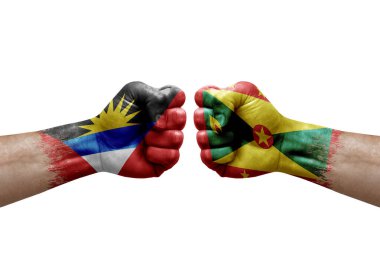 Two hands punch to each others on white background. Country flags painted fists, conflict crisis concept between antigua and barbuda and grenada