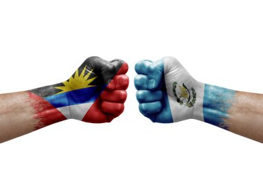 Two hands punch to each others on white background. Country flags painted fists, conflict crisis concept between antigua and barbuda and guatemala
