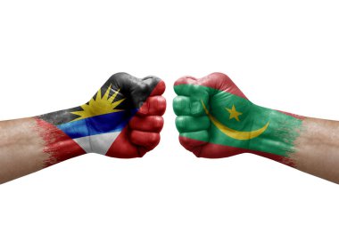 Two hands punch to each others on white background. Country flags painted fists, conflict crisis concept between antigua and barbuda and mauritania